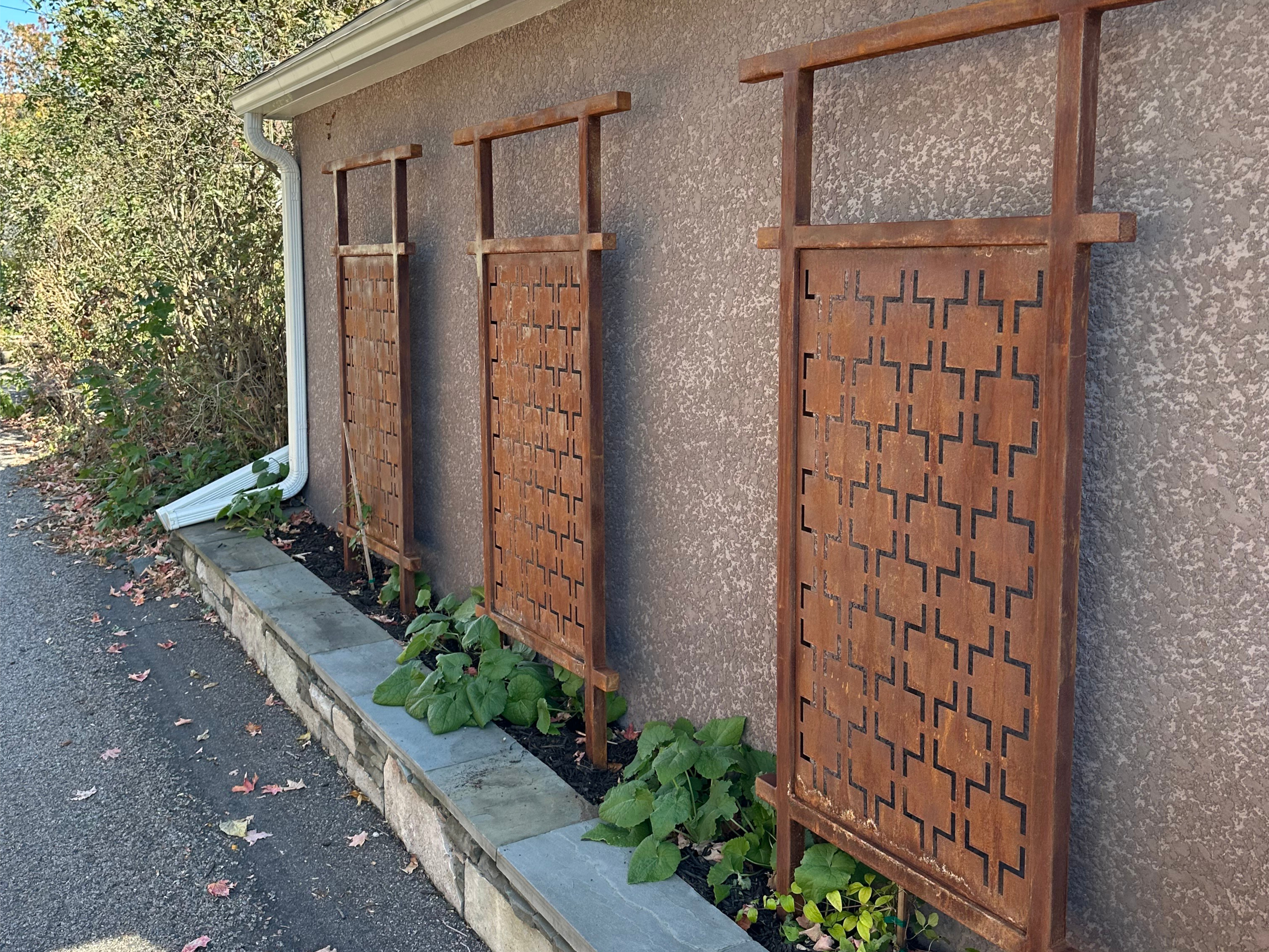 Rustic metal decorative pannels sitting along a garage